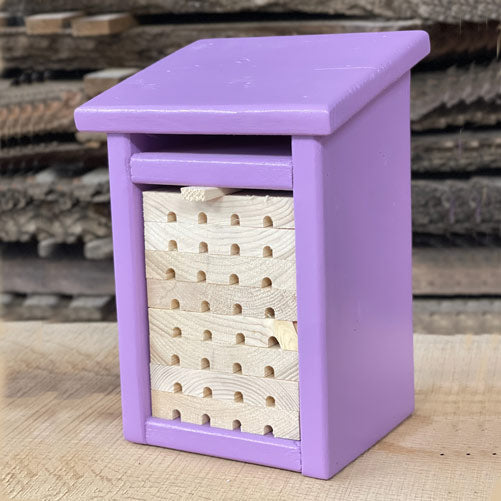 Side profile of wooden pollinator habitat for beneficial garden insects
