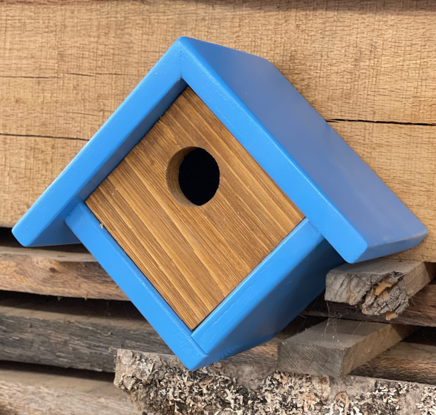 Front view of handcrafted chalet-style birdhouse for small garden birds