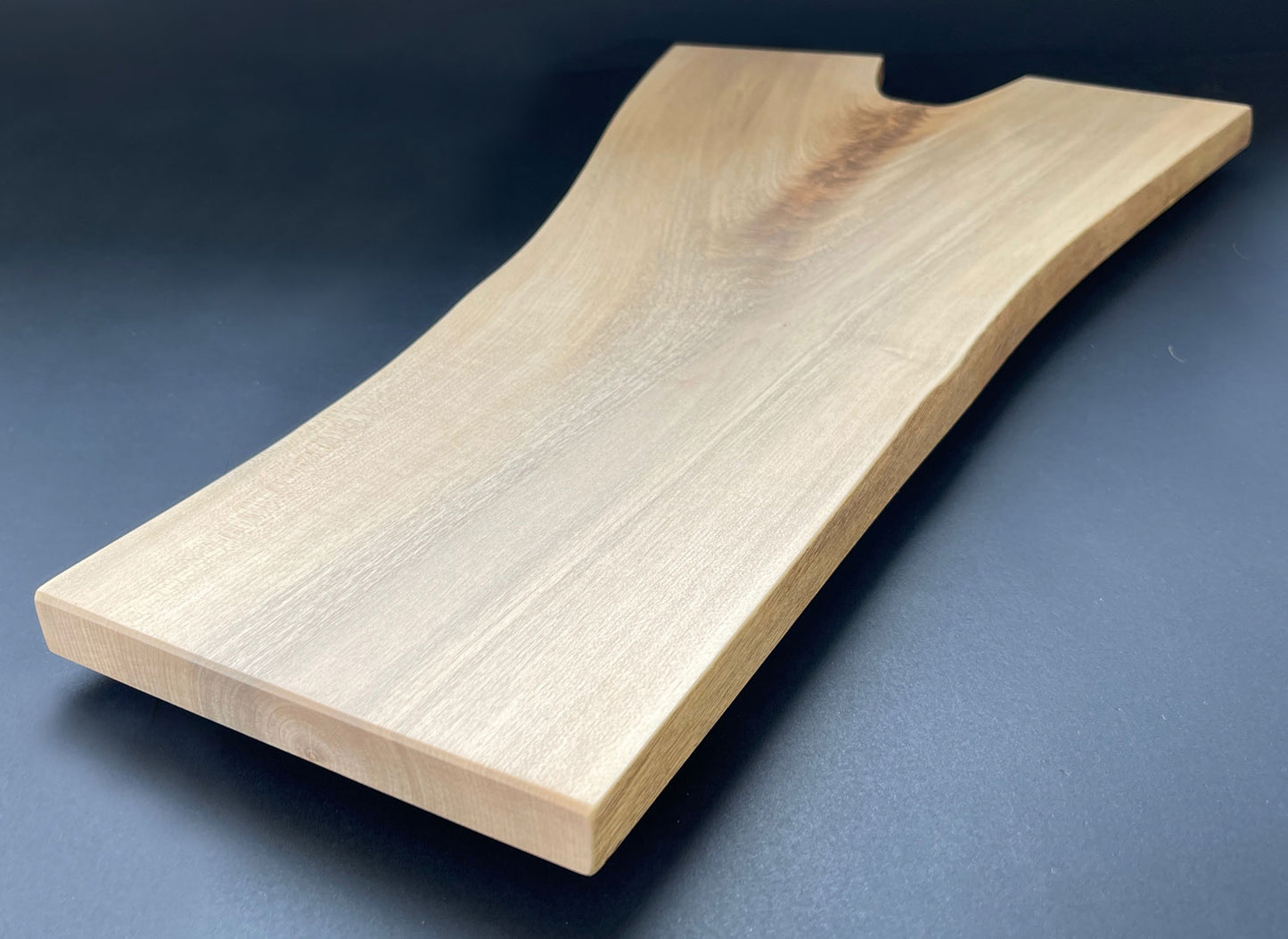 Natural live edge of Y-shaped maple board highlighting wood texture