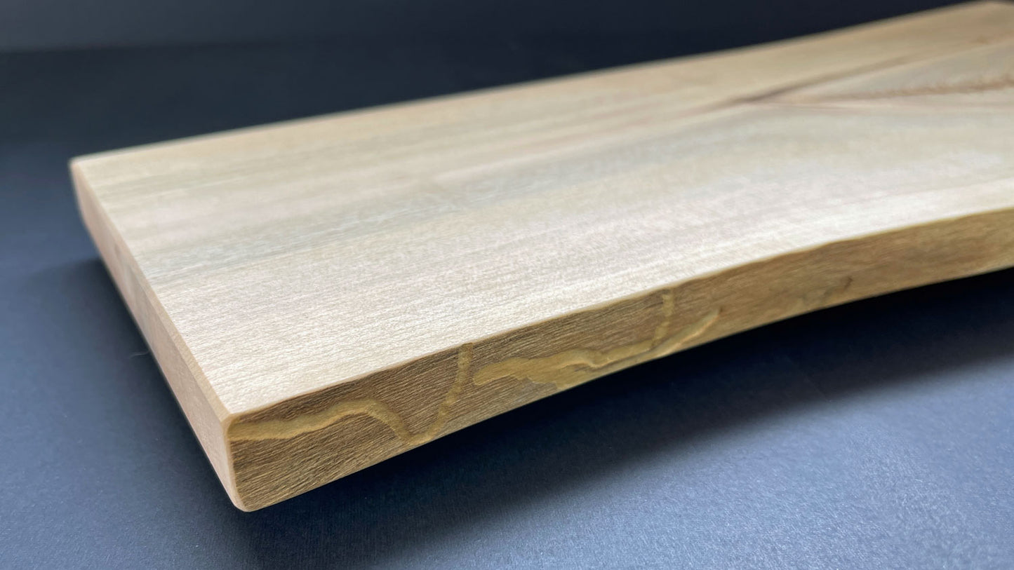 Natural live edge of Y-shaped maple board highlighting wood texture