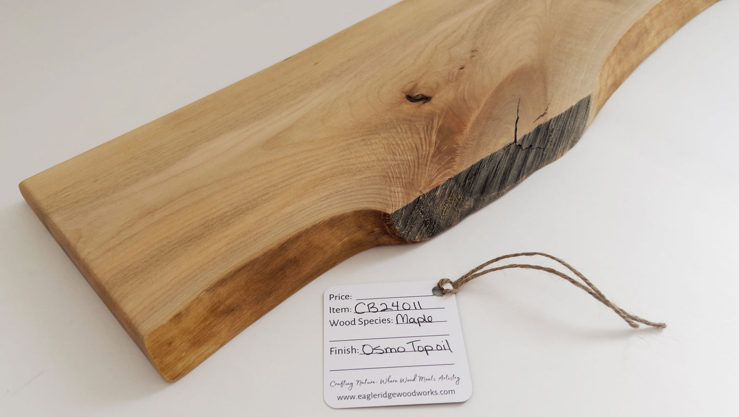 Live edge maple serving board with natural wood grain and circular handle