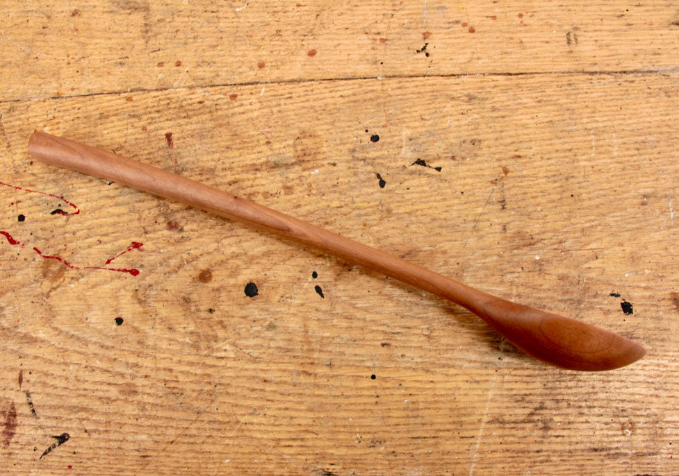 Artisan cherry spoon with ergonomic handle and curved grain