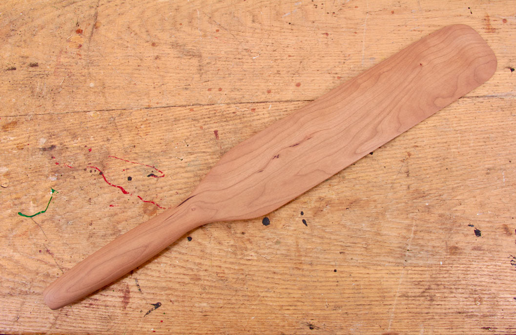 Handcrafted cherry wood spurtle with smooth tapered edges