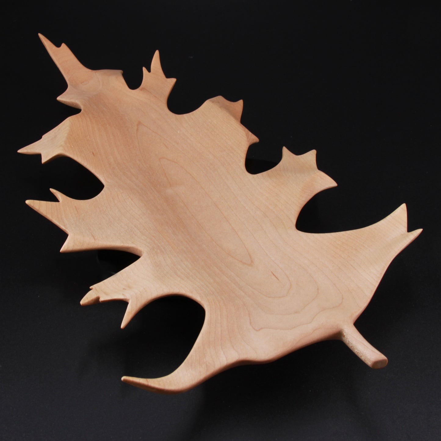 Handcrafted oak leaf dish made from solid wood with natural finish