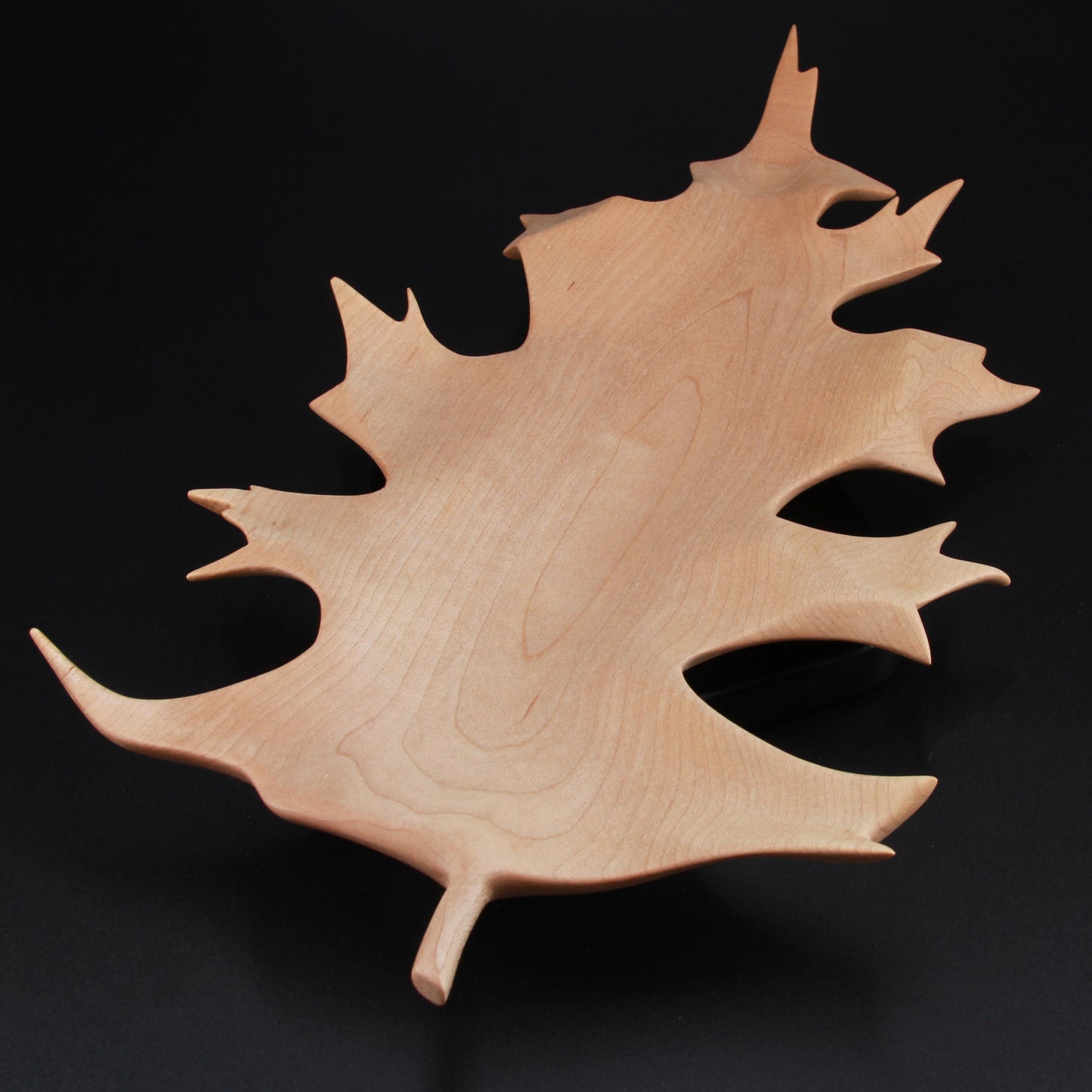 Sculpted wooden oak leaf dish with curved edges and shallow bowl
