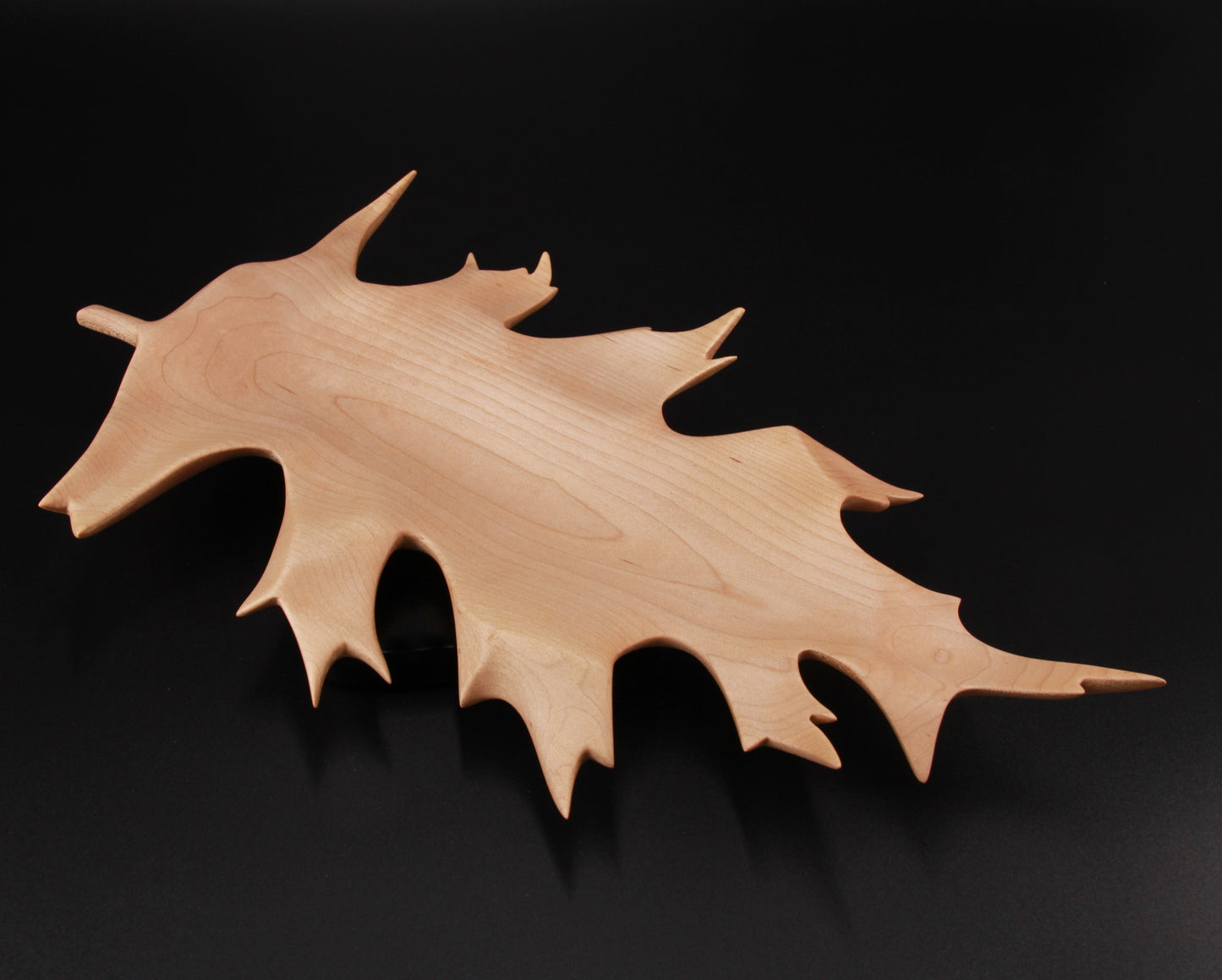 Sculpted wooden oak leaf dish with curved edges and shallow bowl
