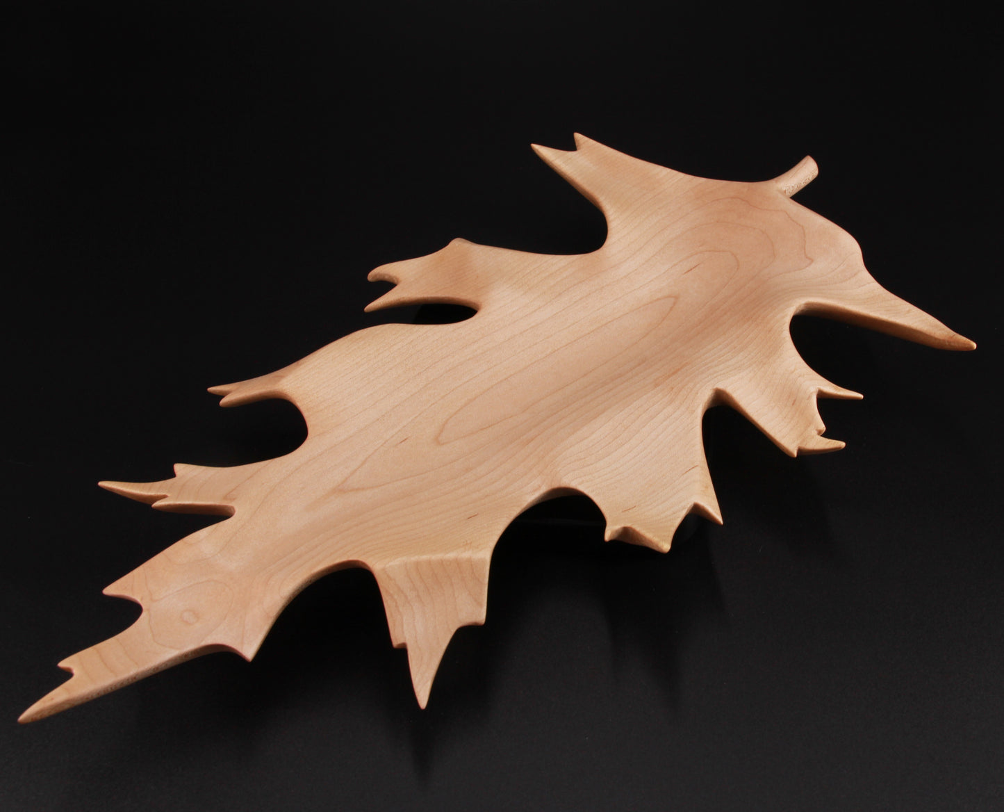 Sculpted wooden oak leaf dish with curved edges and shallow bowl