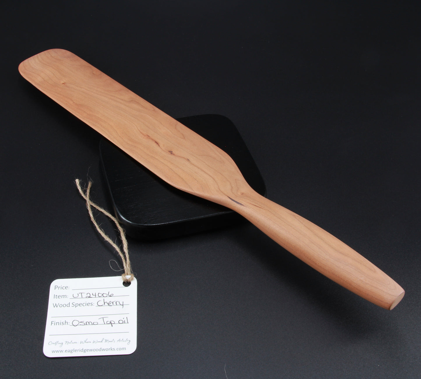 Close-up of cherry wood grain and finish on handcrafted spurtle