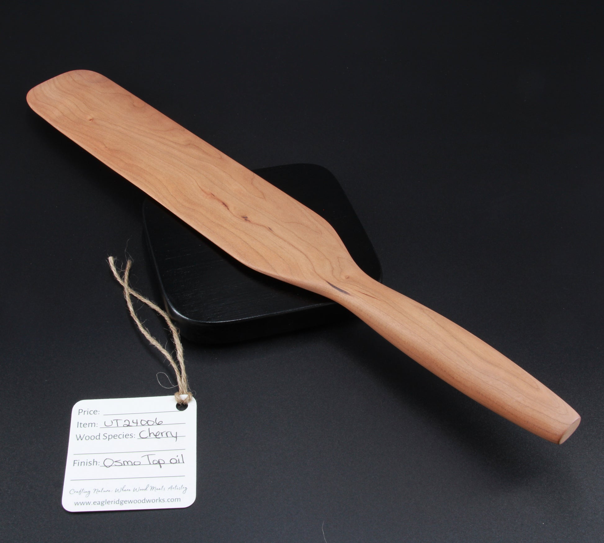 Close-up of cherry wood grain and finish on handcrafted spurtle