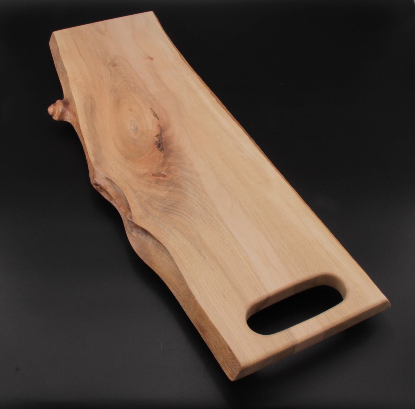 Natural live edge highlighting organic shape and maple wood texture