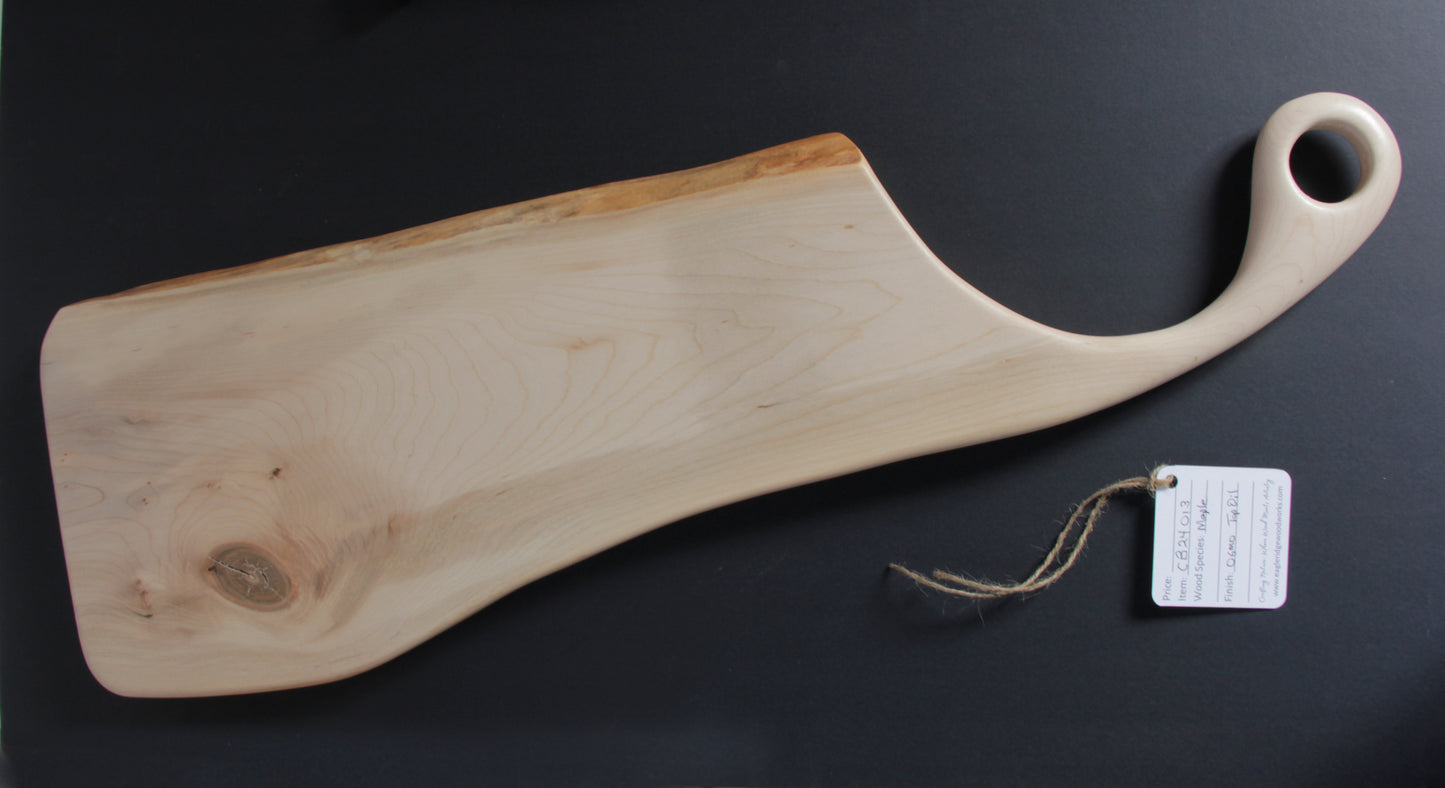 Handcrafted maple charcuterie board with live edge and sweeping handle featuring a hanging loop