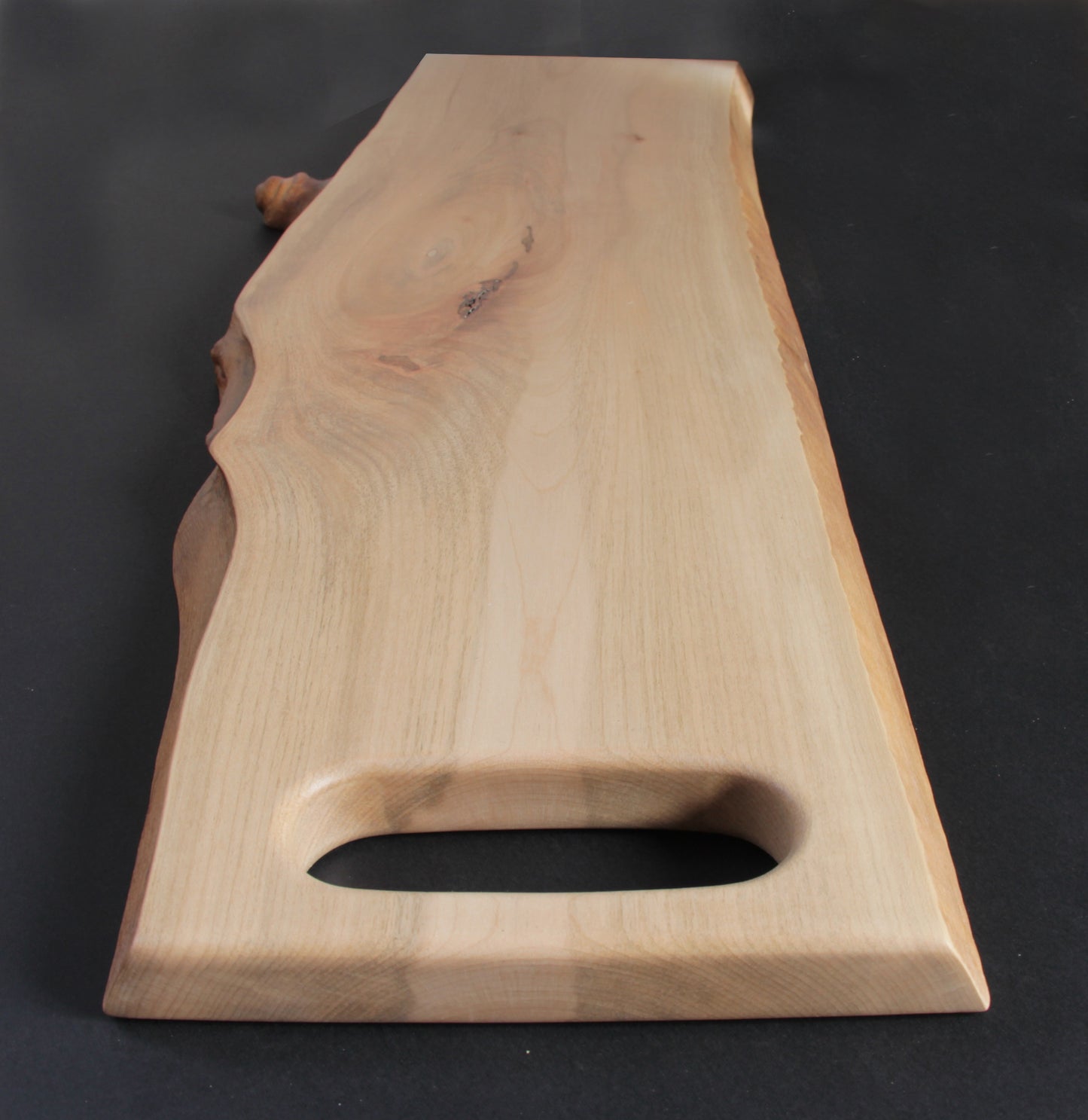 Natural live edge highlighting organic shape and maple wood texture