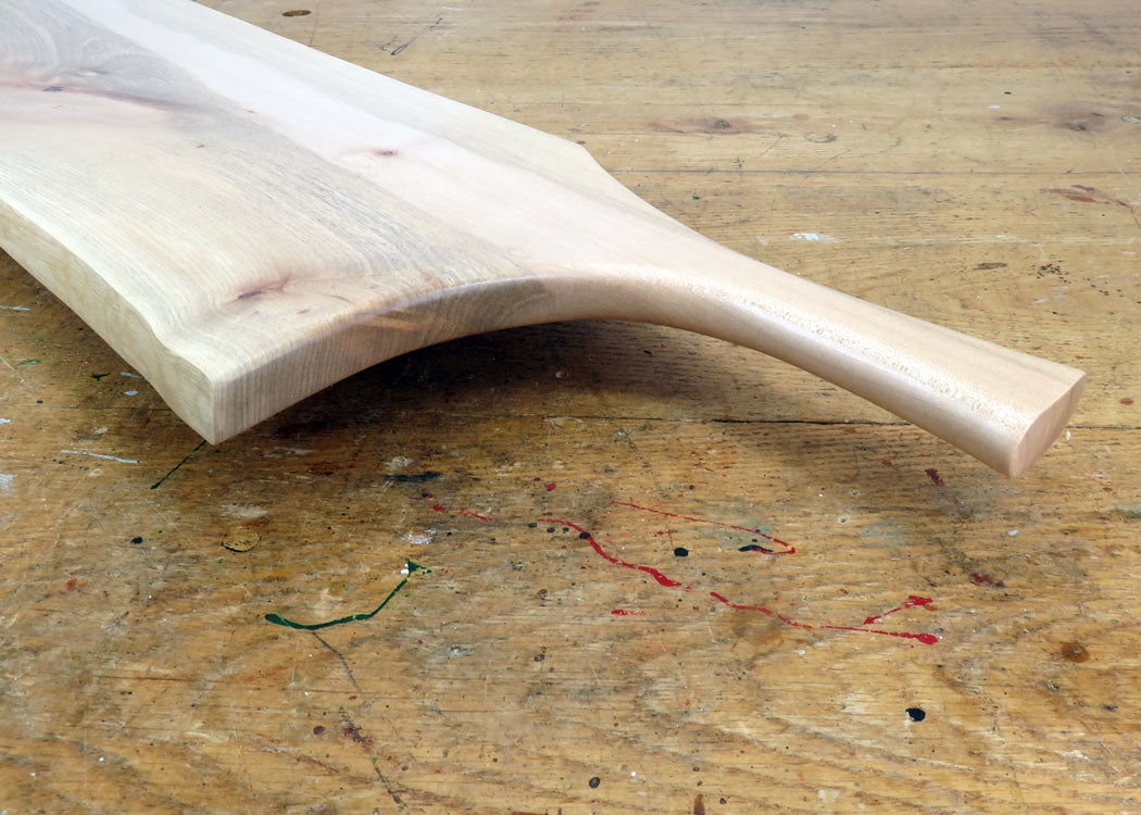Pan-style carved maple handle for easy grip and serving