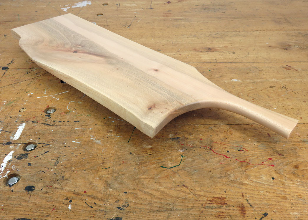 Pan-style carved maple handle for easy grip and serving