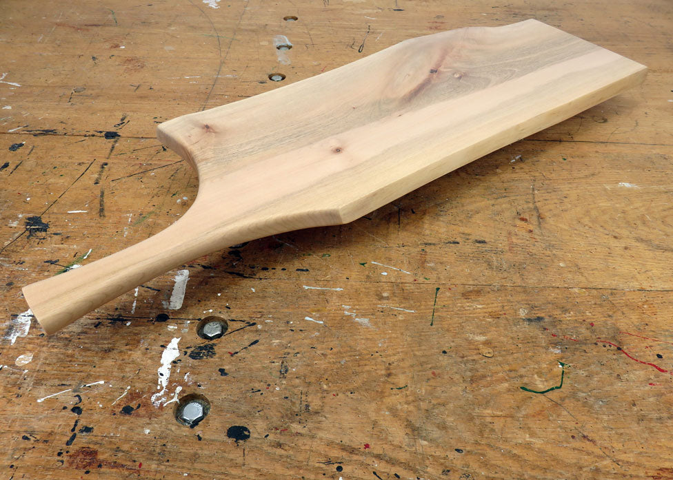 Live edge maple charcuterie board with rustic grain and ergonomic handle