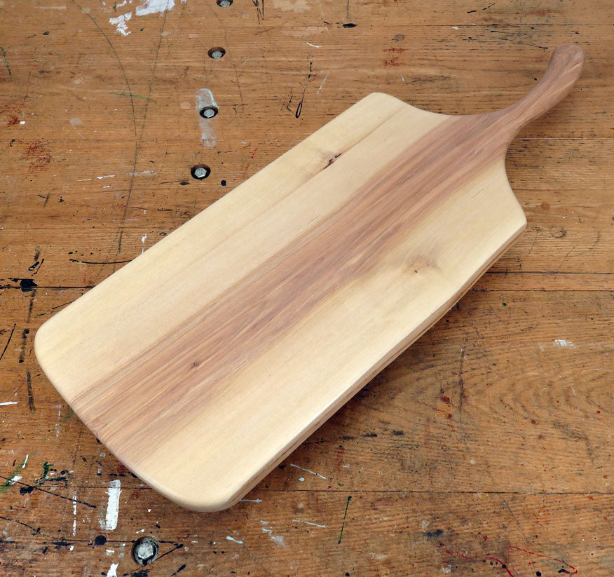 Natural birch wood serving board with rustic live edge and extended handle