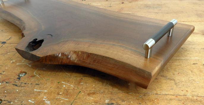 Close-up of black walnut wood grain and live edge detail on charcuterie board