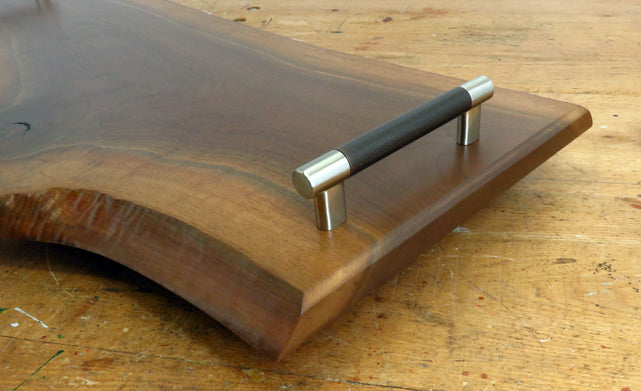 Close-up of black walnut wood grain and live edge detail on charcuterie board