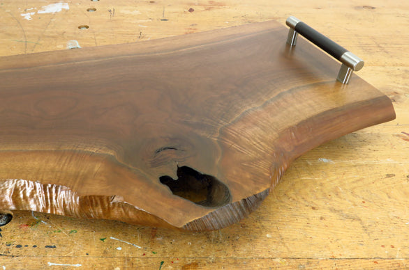 Close-up of black walnut wood grain and live edge detail on charcuterie board