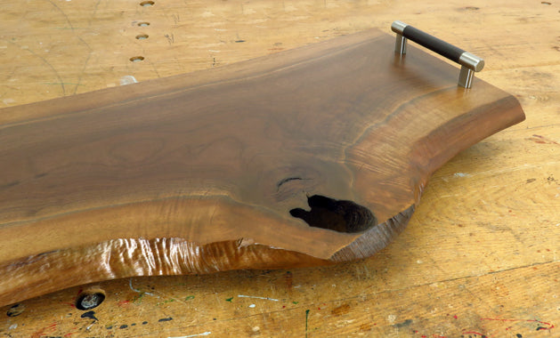 Close-up of black walnut wood grain and live edge detail on charcuterie board