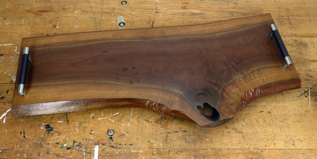 Top-down view of handcrafted black walnut charcuterie board with natural edge