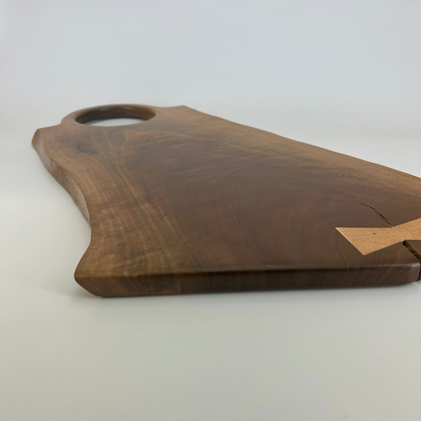Close-up of live edge and natural wood texture on black walnut board