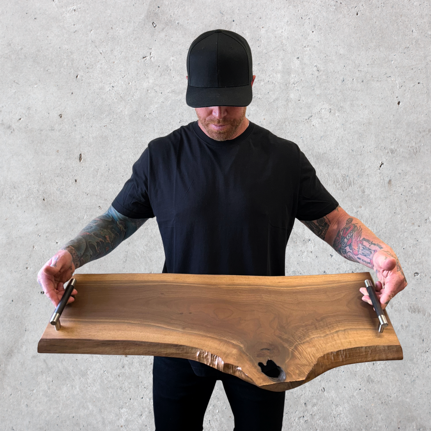 Top-down view of handcrafted black walnut charcuterie board with natural edge