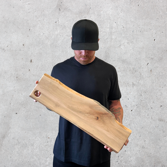 Maple charcuterie board with live edge and round hanging cutout