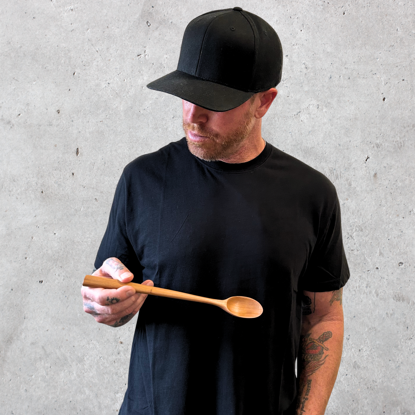 Handcrafted cherry wood cooking spoon with smooth rounded bowl