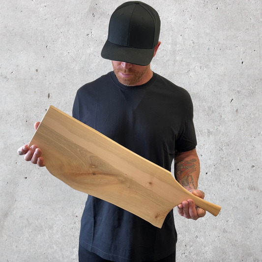 Handcrafted maple charcuterie board with pan-style handle and natural live edge